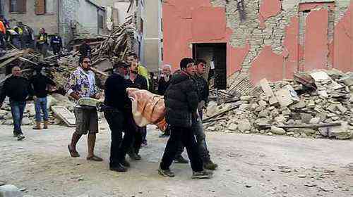 This still image taken from video shows rescuers recover a victim from a crumbled building in Amatrice, central Italy, where a 6.1 earthquake struck just after 3:30 a.m., Wednesday, Aug. 24, 2016. The quake was felt across a broad section of central Italy, including the capital Rome where people in homes in the historic center felt a long swaying followed by aftershocks. (AP Photo)