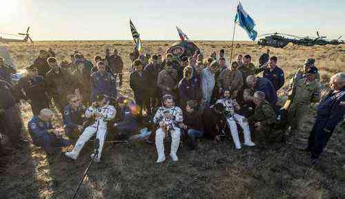 This photo provided by NASA shows NASA astronaut Jeff Williams, left, Russian cosmonaut Alexey Ovchinin of Roscosmos, center, and Russian cosmonaut Oleg Skripochka of Roscosmos sitting in chairs outside the Soyuz TMA-20M spacecraft a few moments after they landed in a remote area near the town of Zhezkazgan, Kazakhstan on Wednesday, Sept. 7, 2016 A record-setting American and two Russians landed safely back on Earth Wednesday after a six-month mission aboard the International Space Station. (Bill Ingalls/NASA via AP)