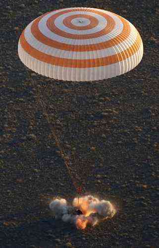 The Soyuz TMA-19M capsule carrying NASA's Jeff Williams, Russian cosmonauts Alexey Ovchinin and Oleg Skripochka touches down beneath a parachute near the town of Zhezkazgan, Kazakhstan, Wednesday, Sept. 7, 2016. The record-setting American and two Russians landed safely back on Earth Wednesday after a six-month mission aboard the International Space Station. (Maxim Shipenkov/Pool Photo via AP)